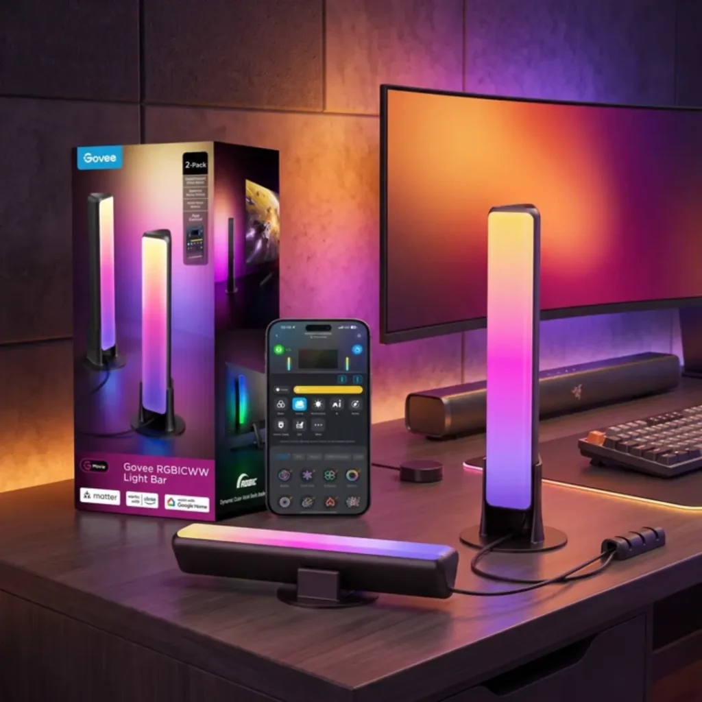 Govee Smart Light Bar RGBICWW ambient TV lights set up next to a PC monitor, considered one of the best desk upgrades for gaming.